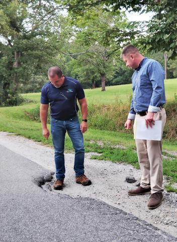 Commission Chairman Travis Turner and White County Manager Derick Canupp examine Garland Bristol Road in front of Fire Station No. 3. DENISE ETHERIDGE/WCN