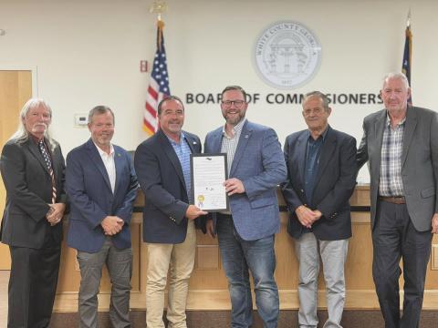 On  Monday, the White County Commission presented Truett-McConnell University President Larry Lyon a proclamation honoring the school's 80th anniversary. From left: Commissioners Craig Bryant and Shan Ash, Chairman Traivs Turner, Lyon, and Commissioners Lyn Holcomb and Ed Nix. PHOTO BY BRYCE BARRETT