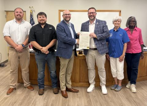 Members of the Cleveland City Council present a proclamation recognizing the 80th anniversary of Truett McConnell University to TMU President Dr. Larry Lyon during the council's July 20 meeting. The proclamation honored the university's eight decades of service to the community. CARLY HENDERSON/WCN 