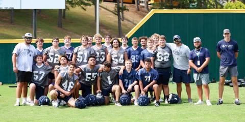 The Warriors' offensive and defensive line pose for a phot during the Fellowship of Christian Athlete's team camp last week at Piedmont University in Demorest.  JENNIFER KNIGHT/SPECIAL