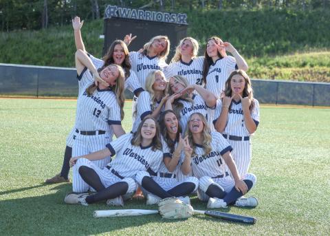 The members of the WCHS varsity softball team have a little fun during a photo shoot Monday afternoon at the WCHS complex . STACI SULHOFF/ SPECIAL