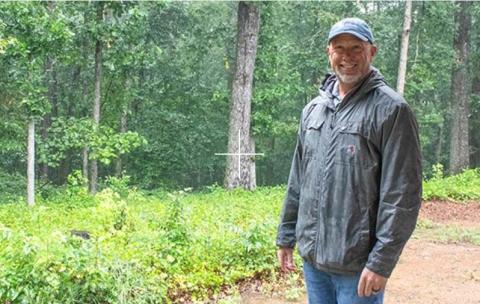 Habitat for Humanity Executive Director Brian Young smiles as he stands on the property that will be the new build site for eight or nine new Habitat homes. HANNAH CAUDELL/CNI
