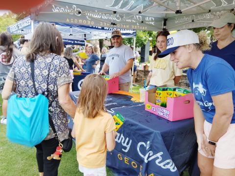 Mt. Yonah Elementary School Principal Juliana Dean, far right, greets a young student at the Back-to-School Bash last Saturday. Assistant principal Ryan London is at far left. At center is first grade teacher Caroline Duffey and behind Dean is instructional coach Jade Bates. PHOTOS BY DENISE ETHERIDGE/WCN