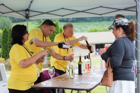 Yonah Mountain Vineyards staffers serve guests samples of wine at Crush Fest 2025. FILE PHOTO