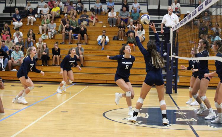 Kyleigh Johnson, right, sets up Hope Thomas for a kill during thea win over West Hall. (Photo/Staci Sulhoff)