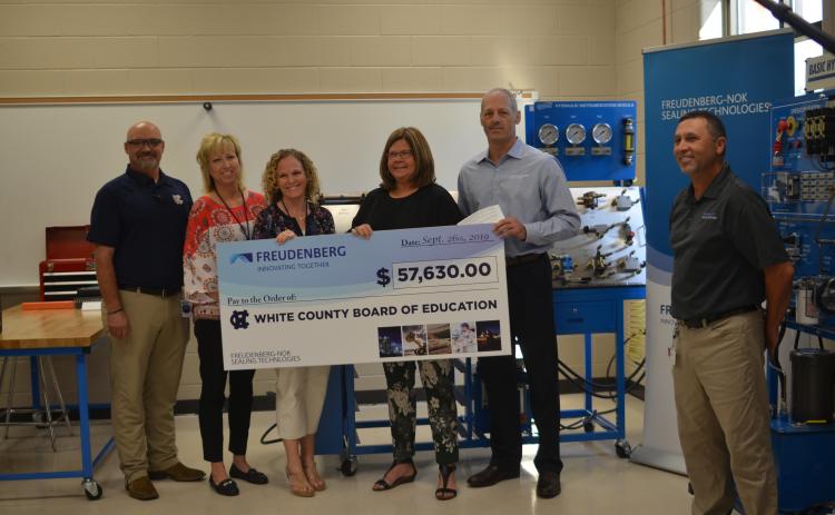 Shown from left are WCHS industrial mechanics teacher Tim Mayo, Assistant Principal Angie Helton, Principal Mary Anne Collier, White County Schools Superintendent Dr. Laurie Burkett, Gary VanWambeke (Freudenberg NOK vice president for Global Lead Center Transmission and Driveline Seals) and Wyman Hare, Cleveland plant manager for Freudenberg NOK. (Photo/Wayne Hardy)