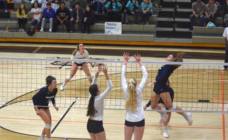Jenna Ash soars for a kill attempt during the Lady Warriors' match against LaFayette Saturday in the Elite Eight matchup. (Photo/Mark Turner)