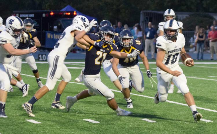 WCHS running back Riley Stancil uses a block from Reece Dockery to turn the corner during the 7-AAAA matchup  against Marist last Friday in Atlanta. (Photo/Mark Turner)