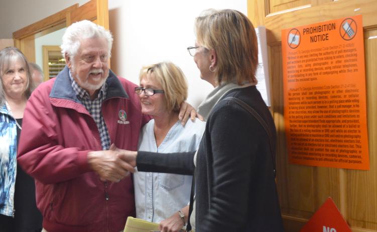 Fred Garmon and Cinnamon Spurlock shake hands after Helen election results are announced. Former city commissioner Dona K. Burke is shown in the middle. (Photo/Stephanie Hill)