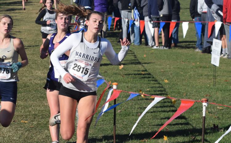 White County's Ellie Gearing, right, holds off St. Pius' Cala McEachron, left, and Chapel Hill's Francie Butts during the final 50 yards of the Class AAAA race to become the first Lady Warrior to cross the finish line. (Photo/Mark Turner)