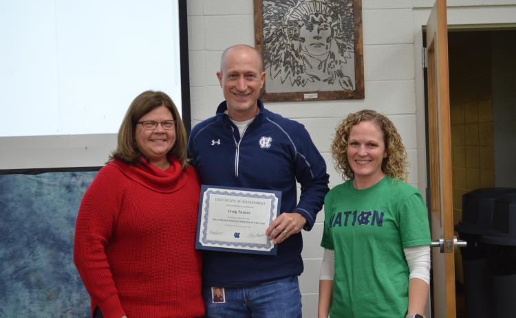Superintendent Dr. Laurie Burkett, left, and WCHS principal Mary Anne Collier, right, present a certificate to Craig Turner. (Photo/Stephanie Hill)