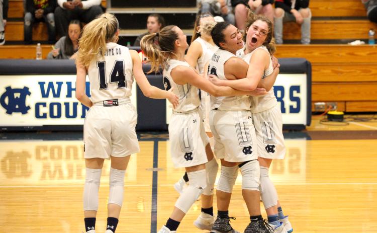 White County basketball players, from left, Rachel Lovell, Dasha Cannon, and Maddie Futch celebrated after closing out a 42-40 win over Chestatee last Friday night in Cleveland. (Photo/Staci Sulhoff)