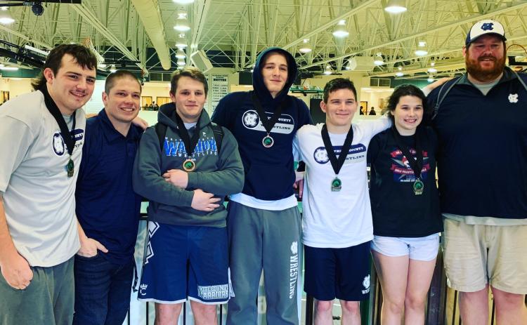 The Warriors had five wrestlers medal at the Burnt Mountain Classic last weekend in Jasper. Shown, from left, are Devin Sullen (285-pound champion), WCHS head coach Patrick Lowendick, Seth Stonecyher (182-pound fifth place), Justin Gilbert (170-pound fourth place), Sean Wurtz (132-pound second place), Sidney Sullens (Girl's 152-pound champion), and assistant coach Nathan Riddle. (Photo/WCHS Wrestling)