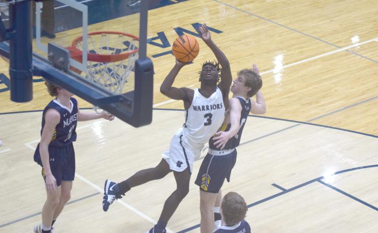 Silas Mulligan gets off a shot in traffic during the opening quarter of the region game against Marist Tuesday night in Cleveland. (Photos/Mark Turner)