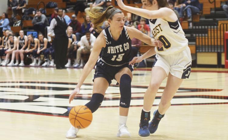 White County's Ellie Gearing, left, tries to dribble past Marist's Maggie Thayer during the opening quarter of the Region 7-AAAA title game Monday night in Flowery Branch. (Photo/Mark Turner)