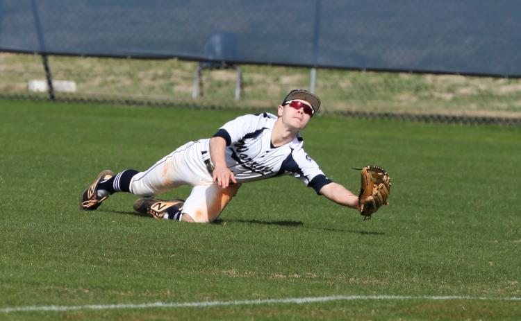 Jake Johnson dives to make a play on a ball during the Warriors' home opener against Habersham Central Saturday in Cleveland. (Photo/Staci Sulhoff)