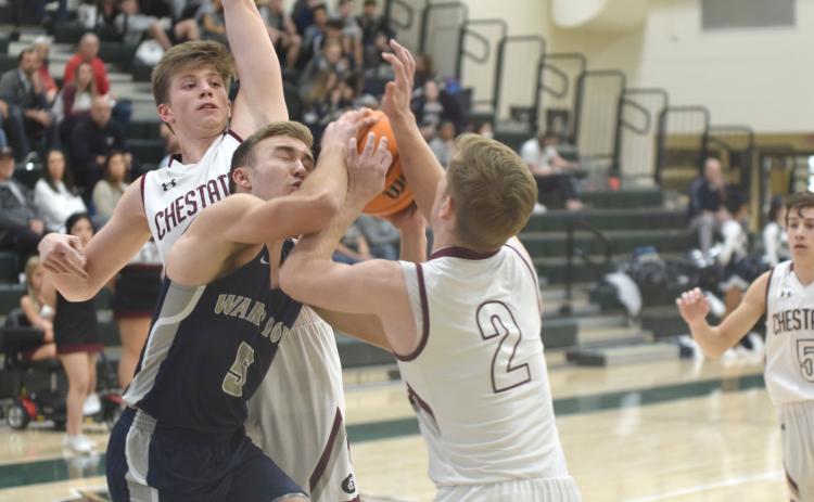 White County's Reece Dockery tries to get off a shot between Chestatee's Ethan Popham, left, and Dylan Travis during the tournament game Monday afternoon in Roswell. (Photo/Mark Turner)