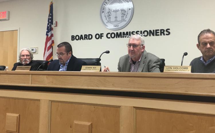 White County Board of Commissioners Chairman Travis Turner (middle) reads aloud the proclamation as fellow commissioners listen, from left Craig Bryant, Edwin Nix and Lyn Holcomb. (Photo/Wayne Hardy)