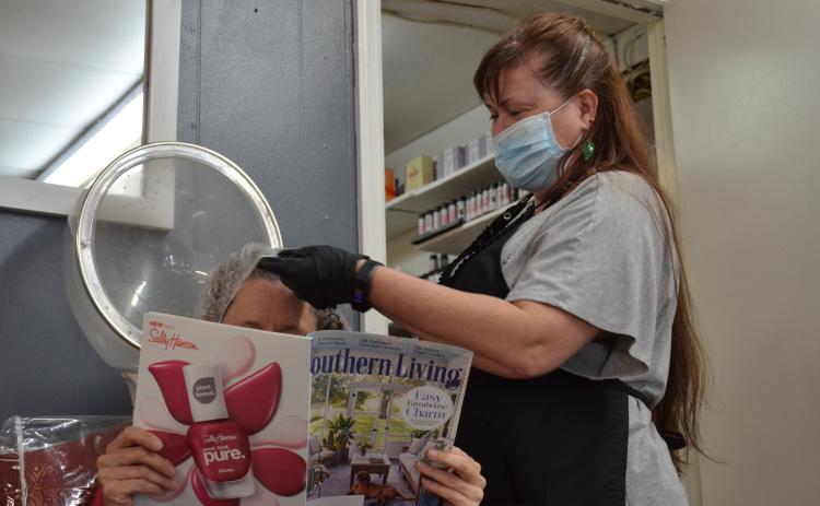 Dee Branson of Creative Styles Hair Salon is among those who felt compelled to reopen for business due to hardships related to the COVID-19 closure. (Photo/Stephanie Hill)