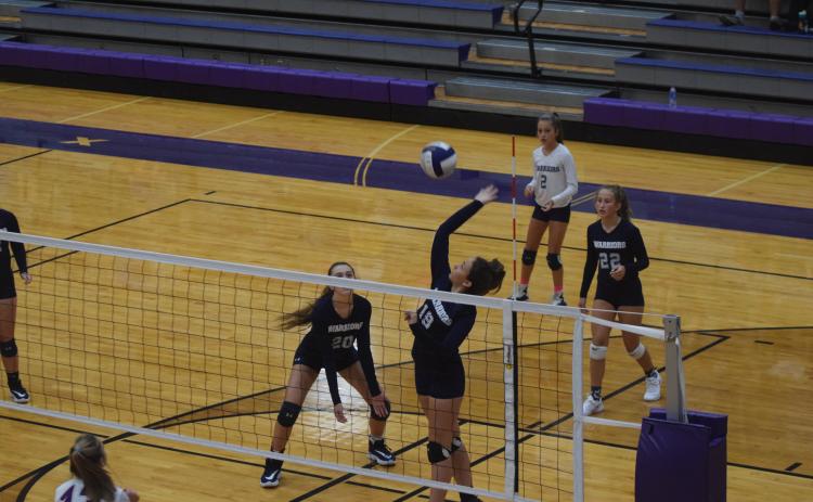 Jenna Pratt goes high for a kill during the semifinal match against Lumpkin County last Saturday in Dahlonega. (Photo/Mark Turner)