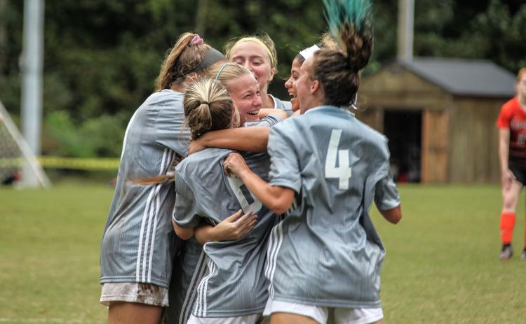 Truett McConnell's Sydney League, center, celebrates with her teammates after scoring the game-winning goal in a 1-0 victory over Union College.  (Photo/TMU Athletics)