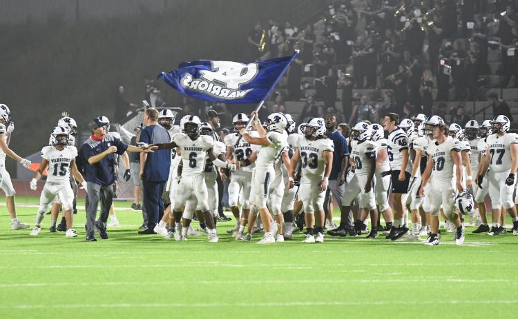 The WCHS players fly the Warrior flag moments after finishing off a 28-21 win over Habersham Central. (Photos/Tom Askew)
