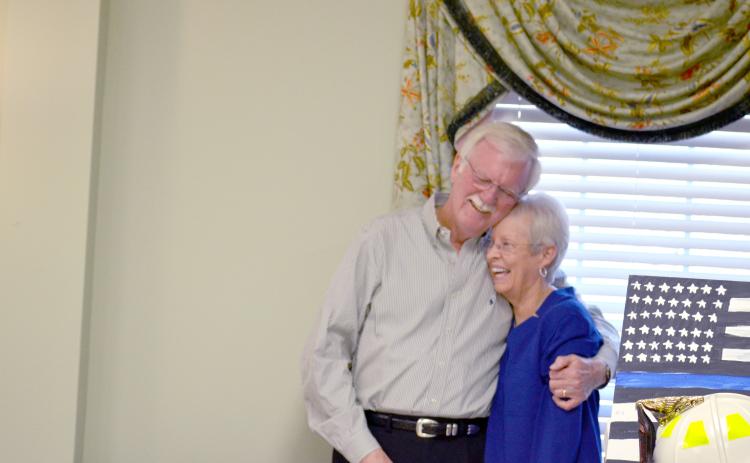 Sheriff Neal Walden hugs his wife, Pam. He thanked family for their support during his career.