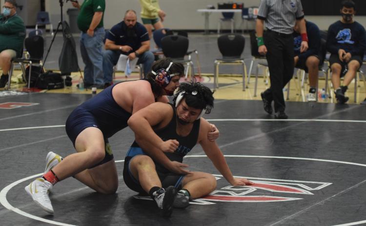 Devin Sullens, left, needed less than two minutes to win two matches and earn the 220-pound title at the Holiday Clash. (Photos/Mark Turner)