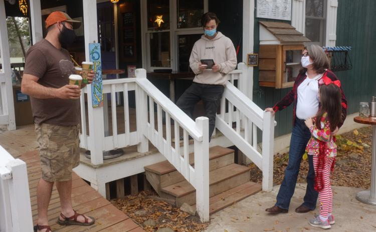 Anna Robertson Bennett and her daughter, Isabel, (right) discuss the upcoming voter registration drive with Sautee resident Dustin Reed (left) and Sweetwater employee River Fox Nickelson (center). (Submitted photo)