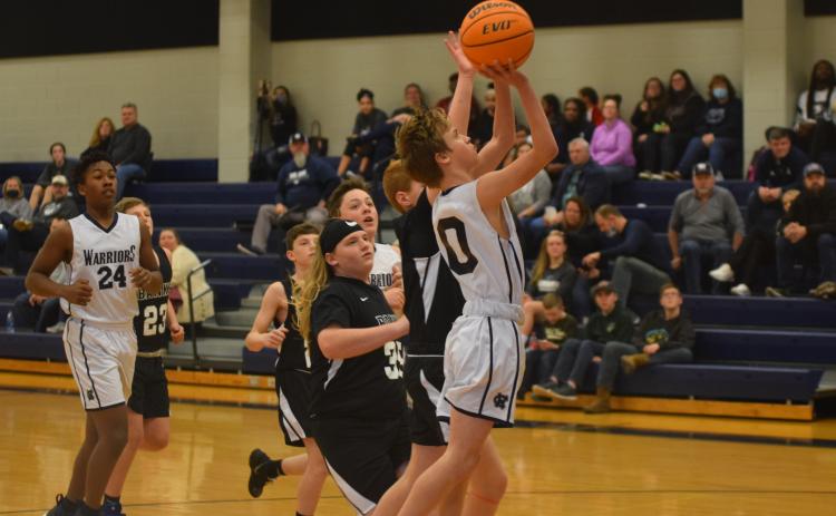 Josh Adams, above, and the seventh-grade boy's team posted a 35-19 opening round win Tuesday over Lumpkin County.  (Photo/Mark Turner)