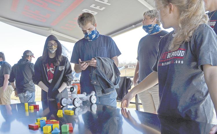 Casen McGuire tries his hand at the robotics station. (Photo/Stephanie Hill)
