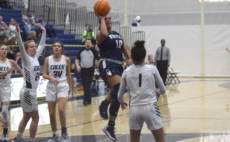 Dasha Cannon scores on a floater in the lane over Coahulla Creek's Ema Turner during the second quarter of the state tournament game Tuesday in Dalton. (Photo/Mark Turner)