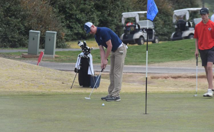 Jacob Adams rolls a putt toward the hole during the tournament last Saturday. (Photo/Mark Turner)