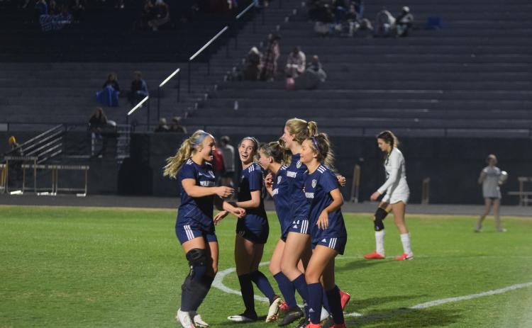 Madison Hunter, left, Leah Alexander, Ada Smith, LaRue Campbell, and Aubrey Dowdy share a hug after the 10-0 win over East Jackson. (Photos/Mark Turner)