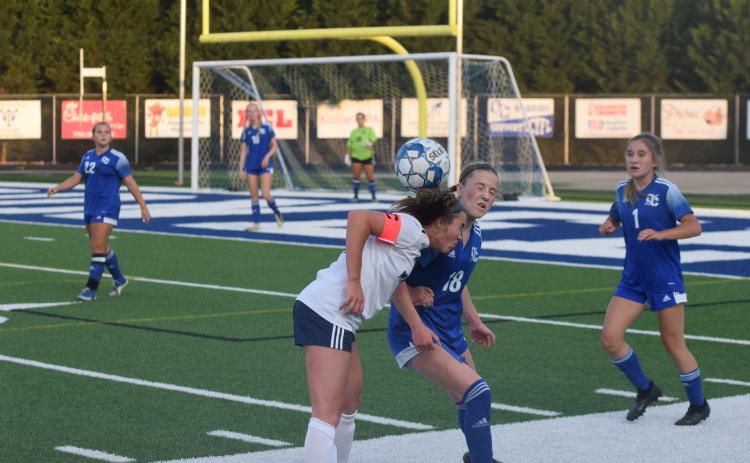 White County's Sydnee Nix, left, collides with Oconee County's Perrin Pennington during the Sweet 16 game Monday in Watkinsville. (Photo/Mark Turner)