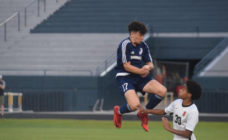 White County's Cohen Cantrell, left, goes up for a header during the Warriors' second round matchup with Greater Atlanta Christian Tuesday in Cleveland.