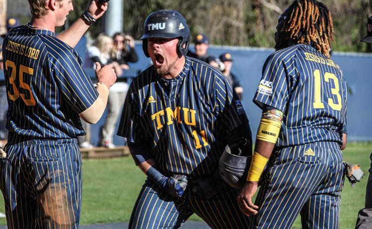 Mason Gaines, left, shown celebrating with Devyn Munroe, had a home run in the Bears' 15-5 win in the opening game of the series.