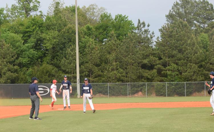 White County's Bailee Patterson, middle, and J. Ben Haynes, right, celebrate after turning a double play to end Game 1 of the Class AAA state baseball series last week in Sonoraville. (Photo/Mark Turner)