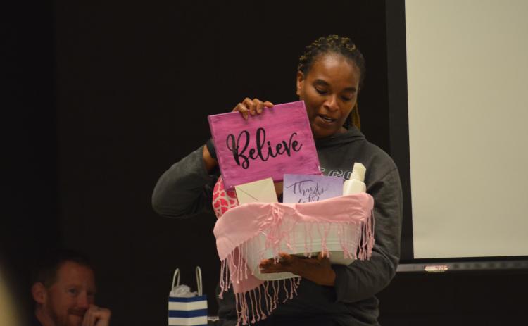 WCMS teacher and KISS Club adviser Debbie Carter-Dye displays some of the goodies in gift baskets prepared for teachers. (Photo/Wayne Hardy)