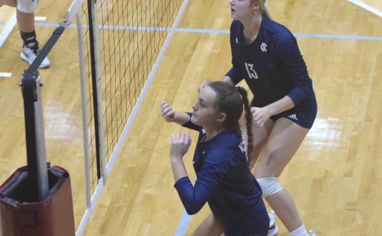 Maggie Blair, left, and Claire Beckman get set to go up for a block during the area win Tuesday night over Dawson County. (Photo/Mark Turner)
