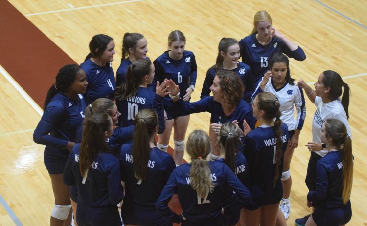 WCHS head coach Shannon Smith, center, talks the Lady Warriors during a recent match. WCHS will be back in action tonight with a tri-match at Jefferson High School. (Photo/Mark Turner)