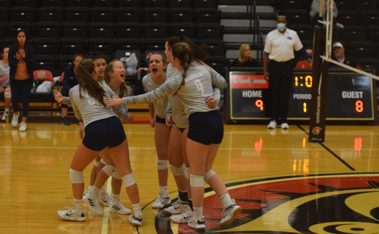 Brooklyn Thomason, left, and Maggie Blair celebrate after a point during the opening set of the first round match Tuesday at Greater Atlanta Christian. (Photo/Mark Turner)
