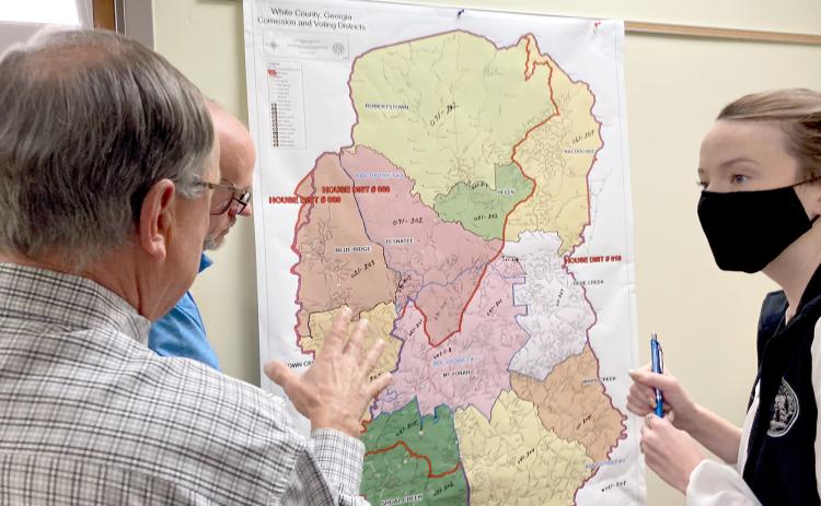 White County Elections Director Akyn Bailey, right, speaks with White County Board of Elections and Registration members (from left) Dwayne Turner and Todd Marks about precinct line updates at a Dec. 6 meeting. (Photo/Wayne Hardy)