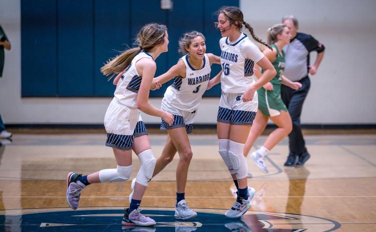 Kylie Watkins, left, and Naomi Roberts, right, celebrate with Aaliyah Anderson moments after Anderson hit a shot at the buzzer to knock off Pickens County 53-52 in a region matchup Tuesday in Cleveland. (Photo/Austin Barrera)