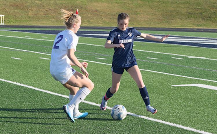 Liz Williams, right, and the Lady Warriors' defensive back line will try to slow down Hebron Christian in the opening round of the Class AAA playoffs.  (Photo/Mark Turner)