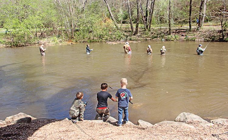 Over 700 contestants registered for this year’s 34th Annual Trout Tournament in Helen over the weekend. Above, the younger generation observes the old on the banks of the Chattahoochee River. (Photo/Jessica Wood)