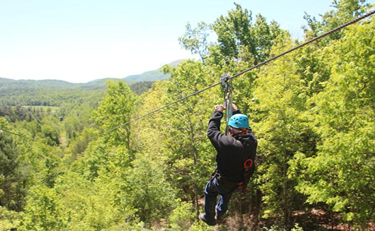 Leon White goes down “The Intimidator,” a half mile long zip line at Nacoochee Adventures with views of Mt. Yonah. (Photo/Jessica Wood)