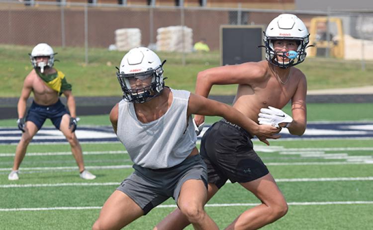WCHS linebacker Jon Scott, left, covers John Phillips during Tuesday's workout at Warrior Stadium.  (Photo/Mark Turner)