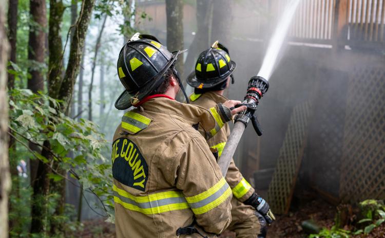 White County Firefighters and EMTs Frank Tirino and Jeffery Johansen work together to control the fire. (Photo/submitted)