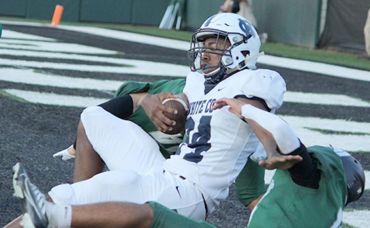 Noel Lammers drags down a couple of North Hall defenders at the end of a 16-yard touchdown run to tie the game at 7-7 in the first quarter. (Photos/Mark Turner)